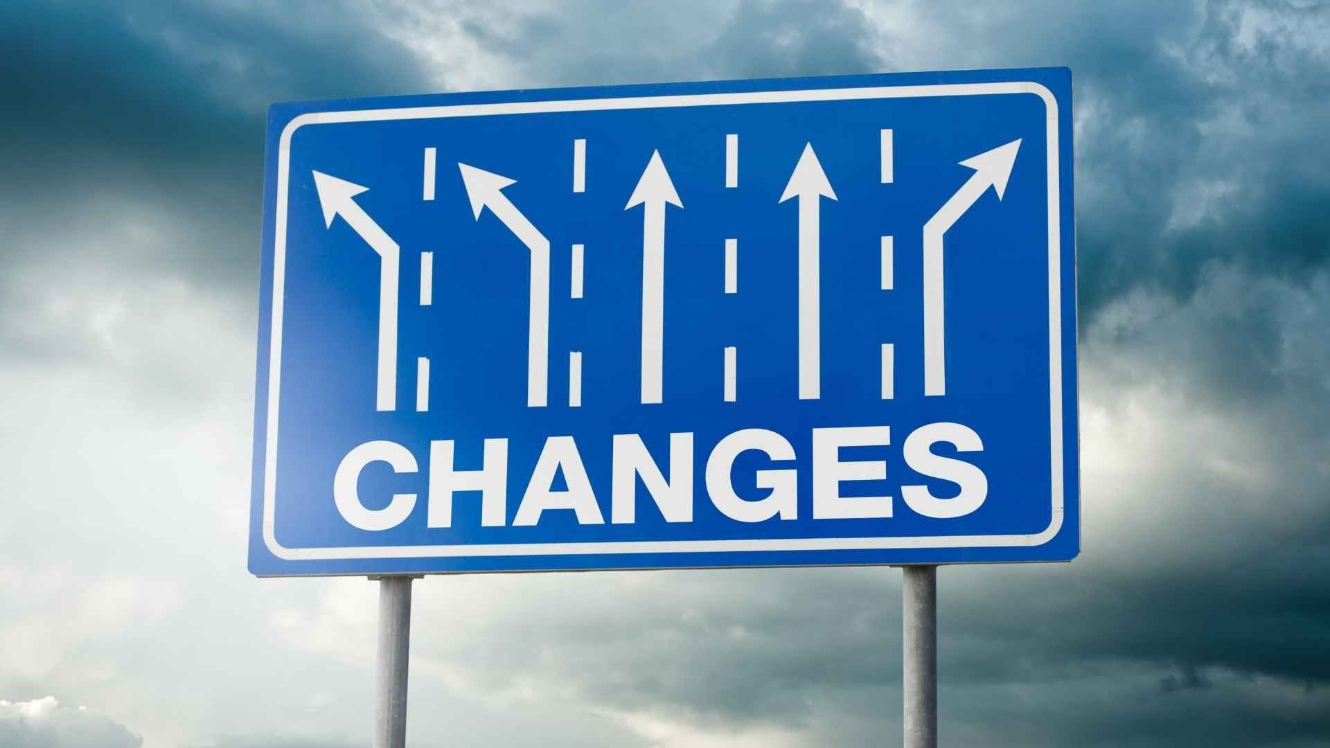 A blue sign that says changes with arrows pointing in different directions