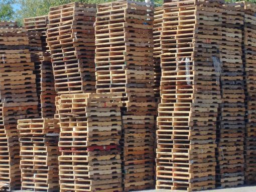 A large pile of wooden pallets stacked on top of each other