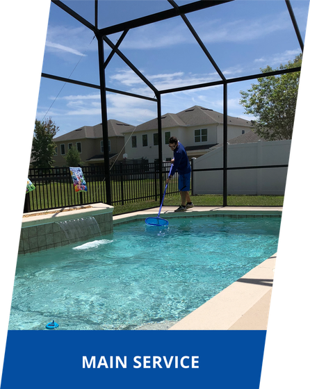 A man is cleaning a swimming pool with a vacuum cleaner.