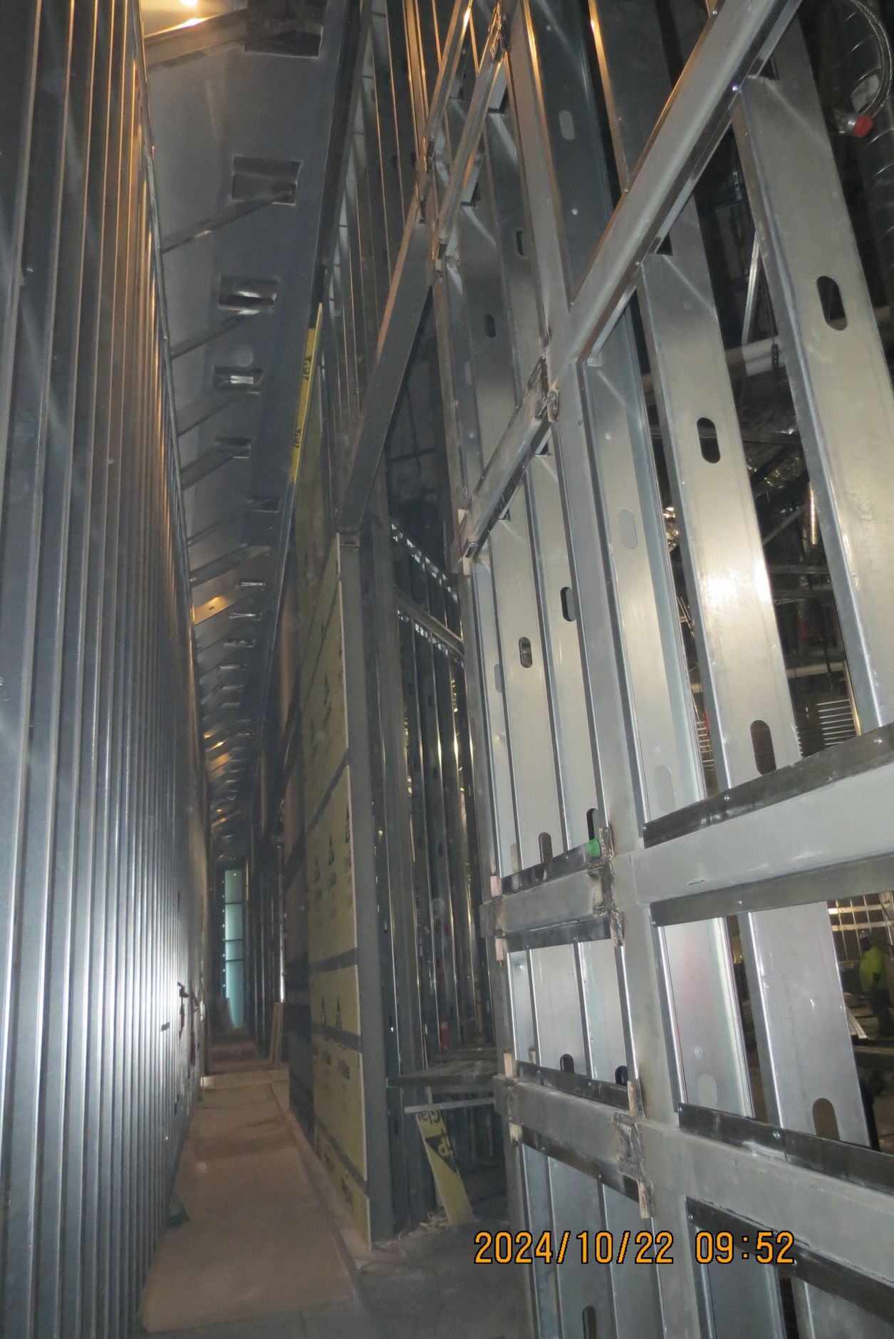 Interior of a metal structure with a narrow walkway, possibly industrial.
