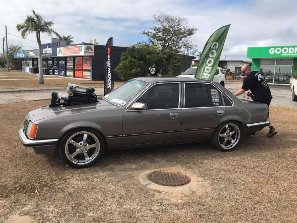 A Gray Modified Sedan With A Large Engine Intake Stands In A Parking Lot — THG Tires in Gladstone Central, QLD