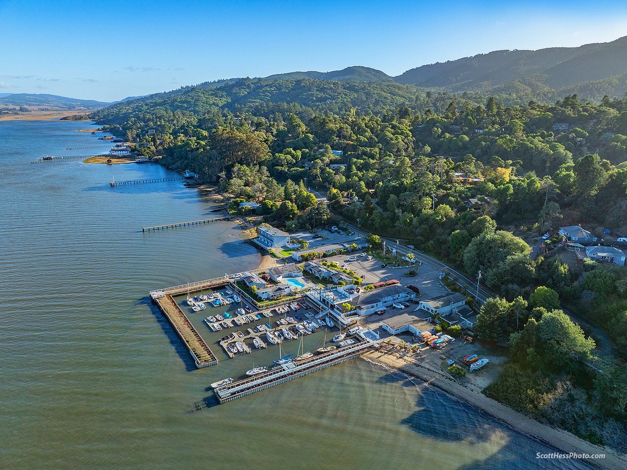 An aerial view of a marina with boats docked in the water.