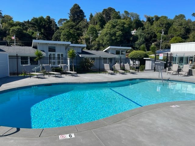 A large swimming pool with a no diving sign on the edge
