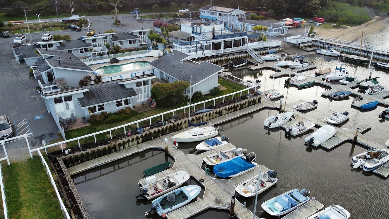 An aerial view of a marina filled with boats and buildings.