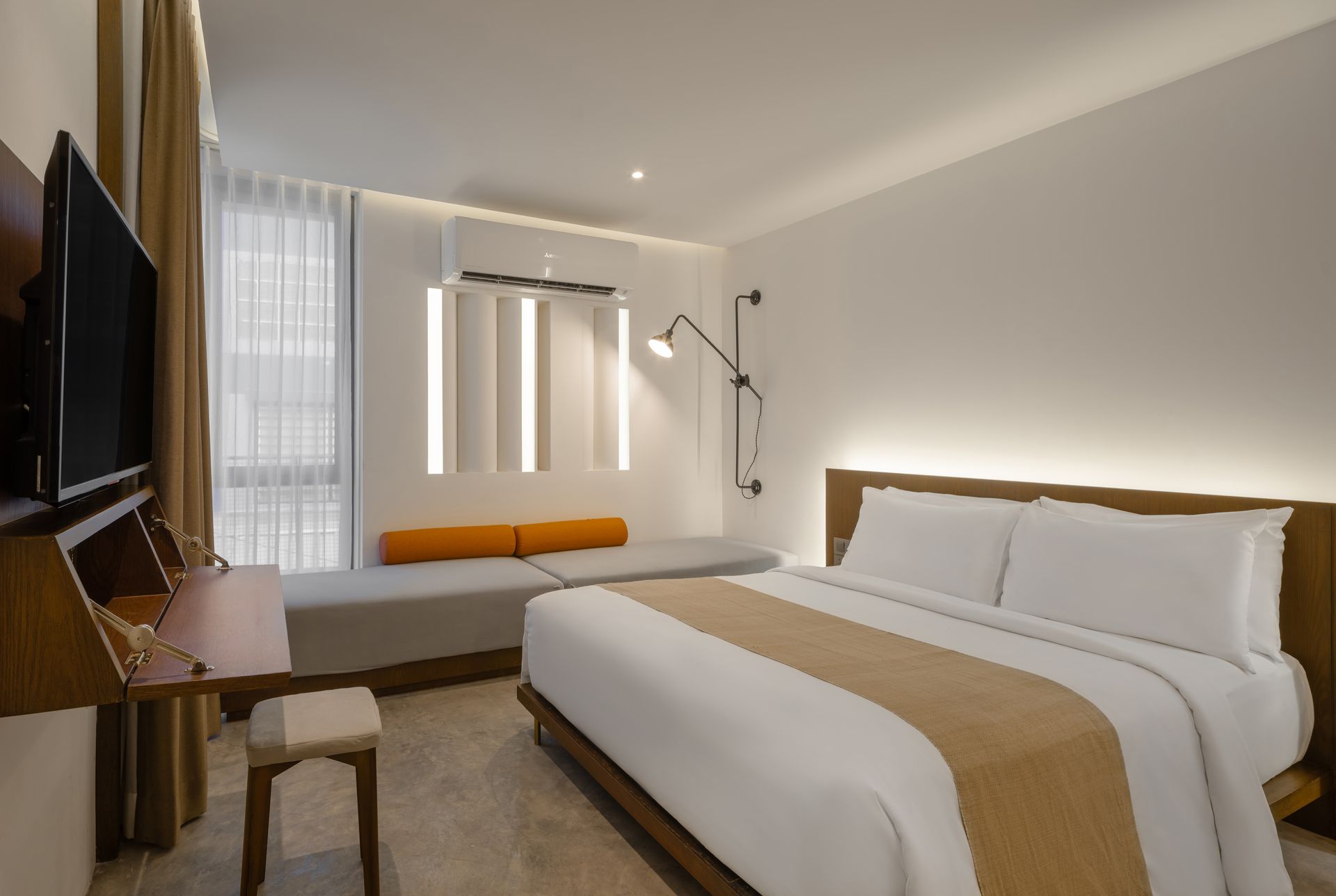 Superior Plus Double Room with double bed, small sofa seating area, and warm ambient lighting