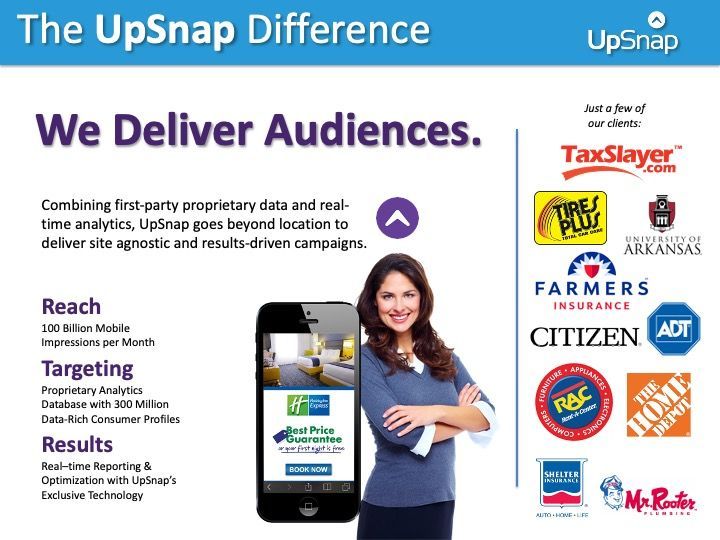 A woman is standing in front of a phone with the words we deliver audiences on it.