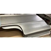 Metal car body panel.  Gray steel, curved shape, for repair or restoration work.