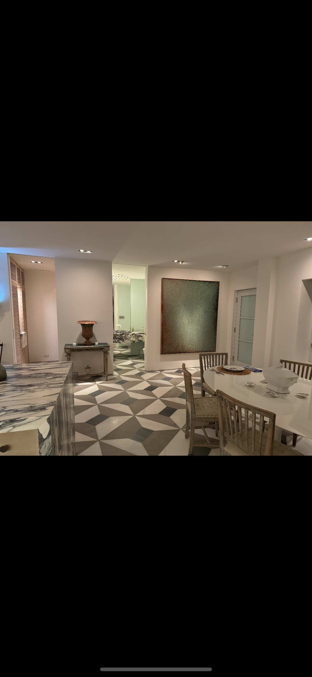 A large room with a table and chairs in it.
