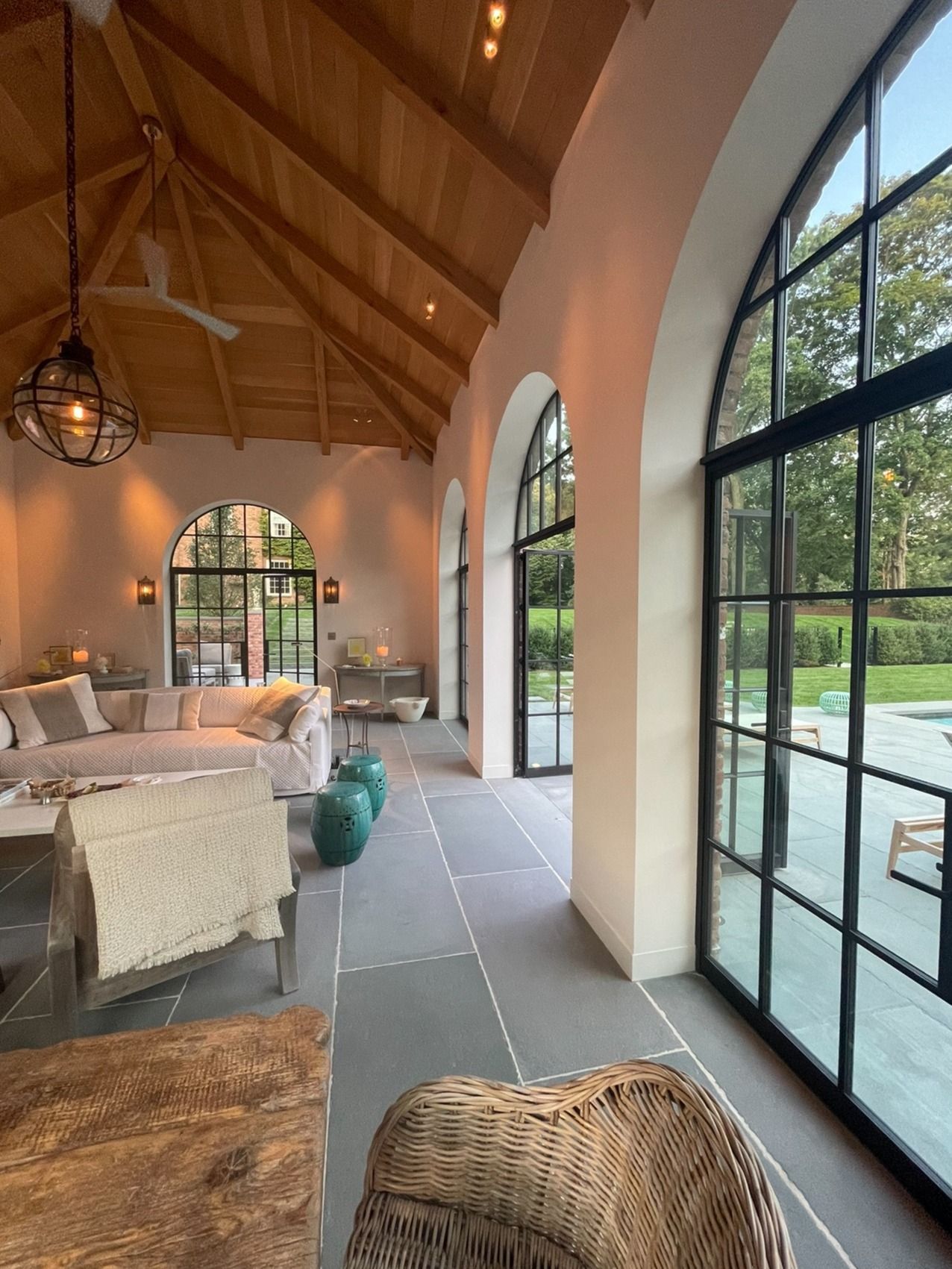 A living room with a lot of windows and furniture