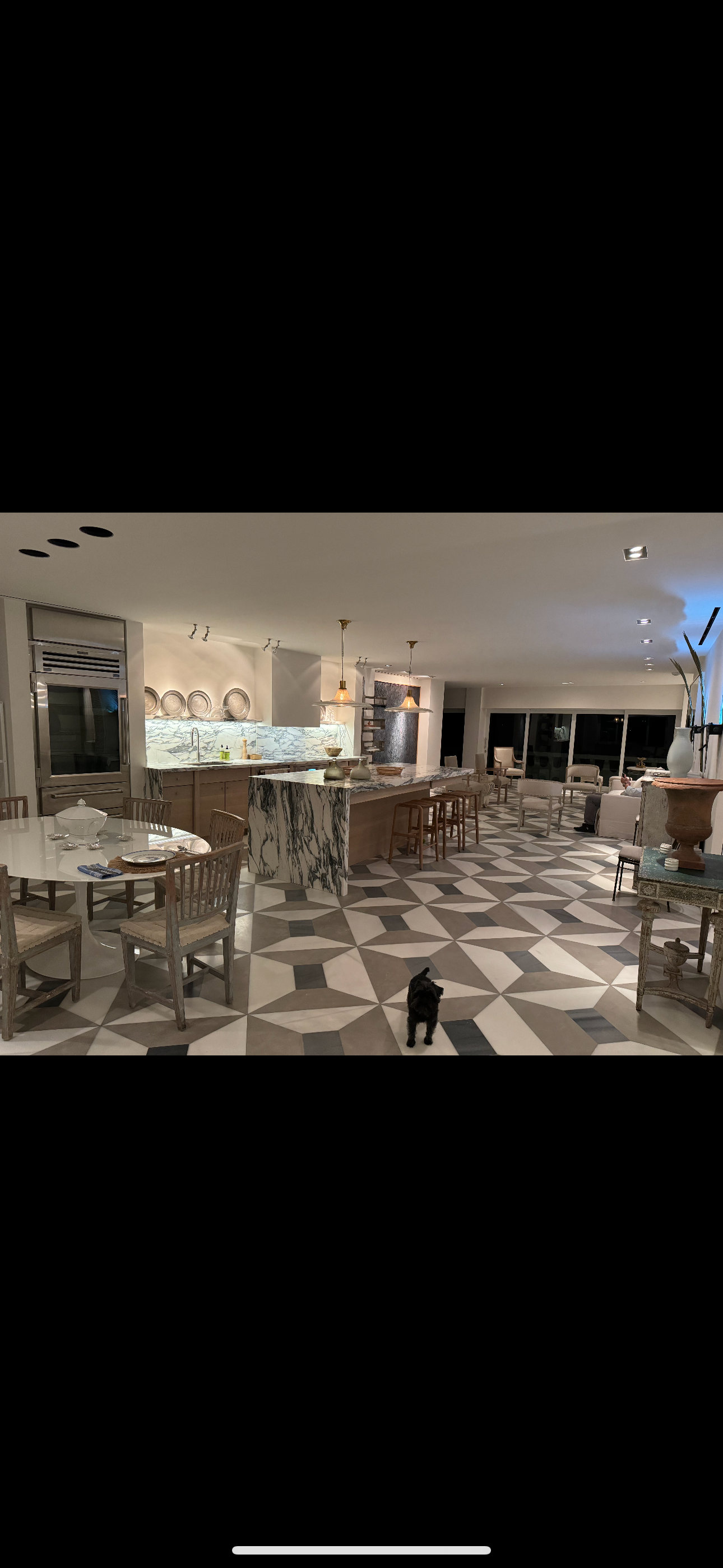 A large room with tables and chairs in it.