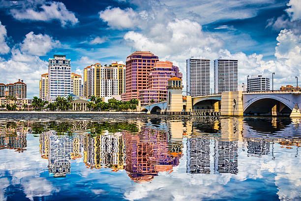 The skyline of a city is reflected in the water.