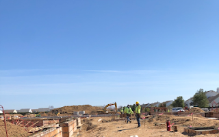 A group of construction workers are walking through a construction site.