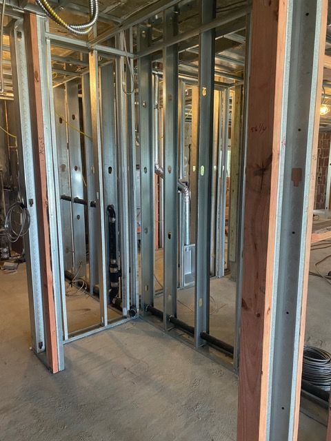 Interior wall framing with metal studs in an unfinished construction site