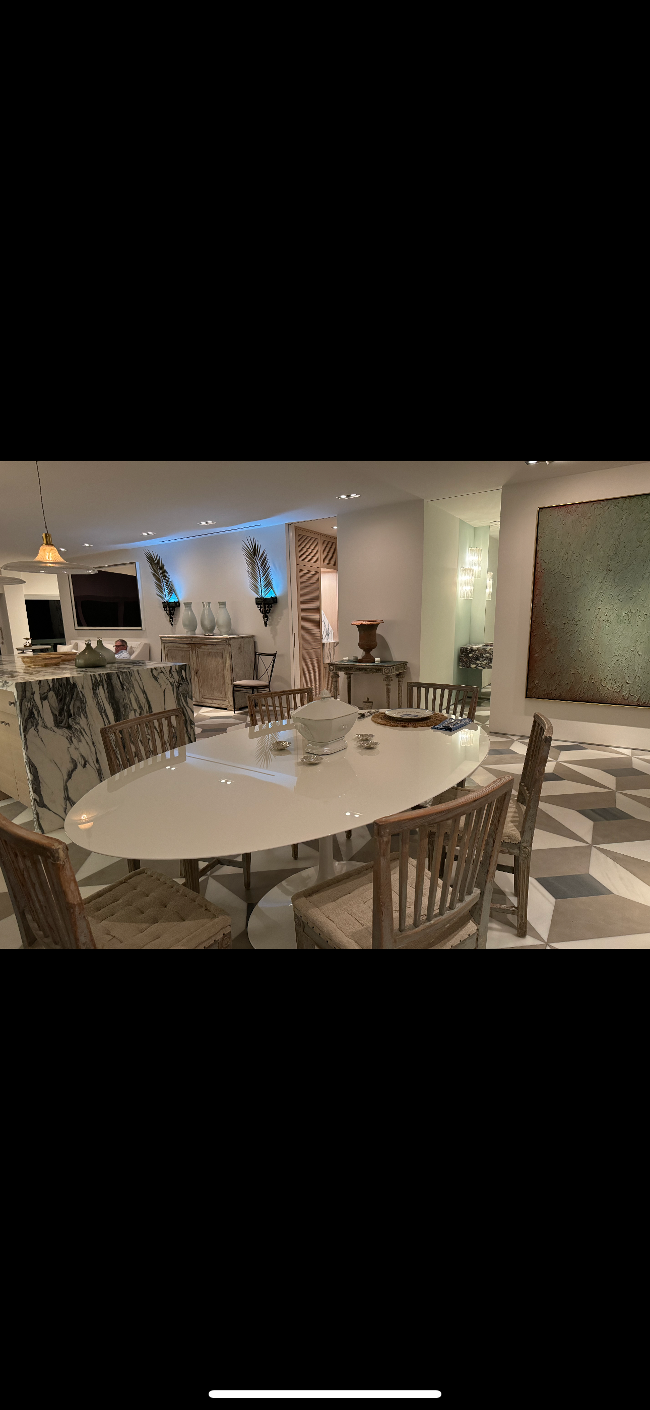 A large room with a table and chairs in it.
