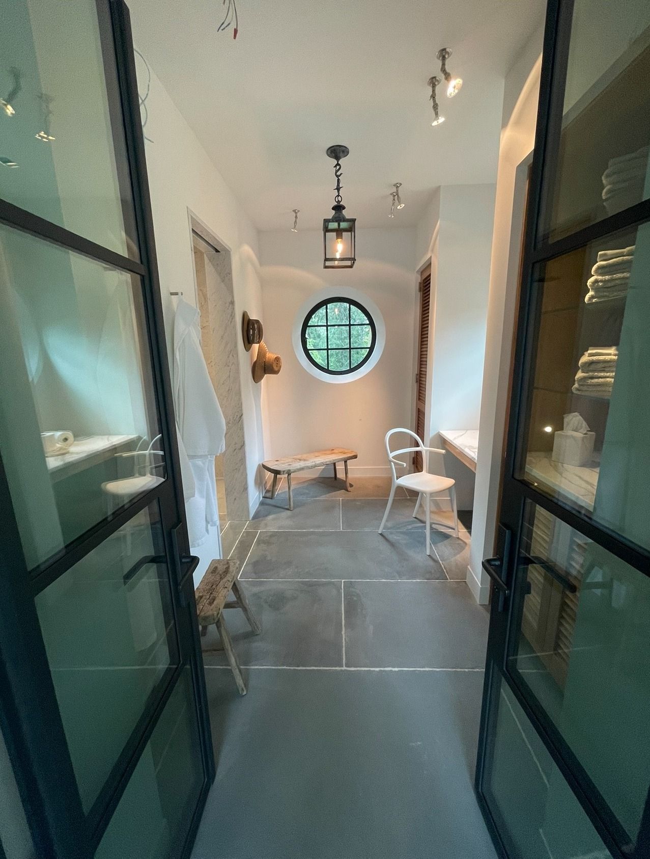 A hallway with a round window in the middle of it.
