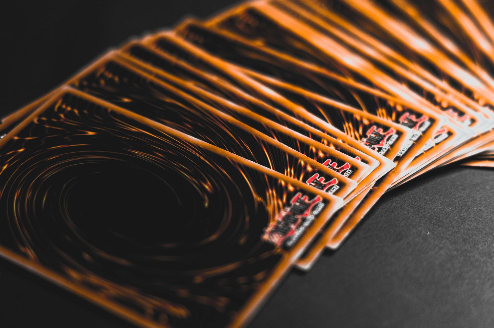 Orange light streaks forming a curved abstract pattern on a dark background