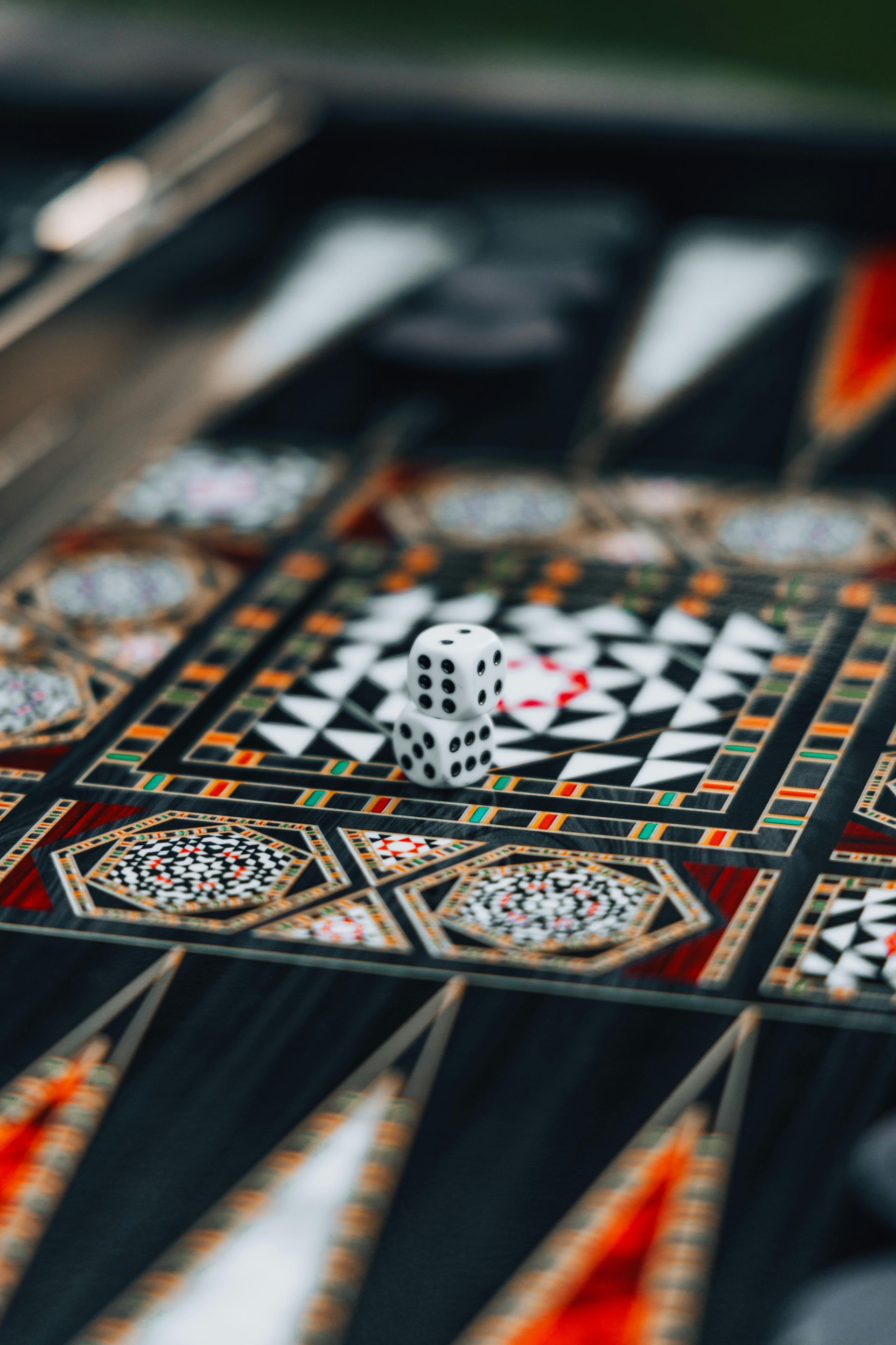 Decorative mosaic table with a black-and-white geometric center and colorful patterned border