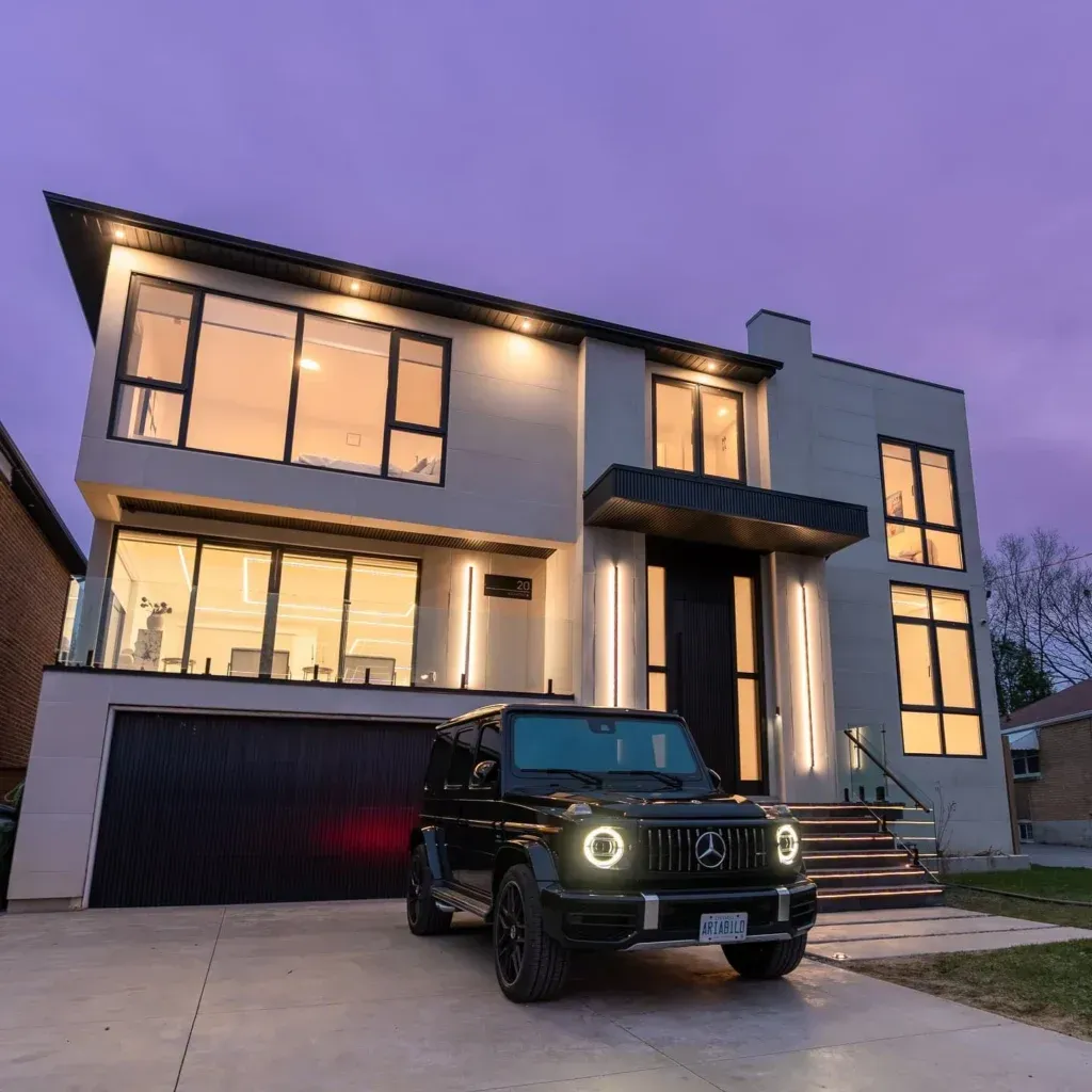Modern two-story house at dusk with a black SUV parked in the driveway.