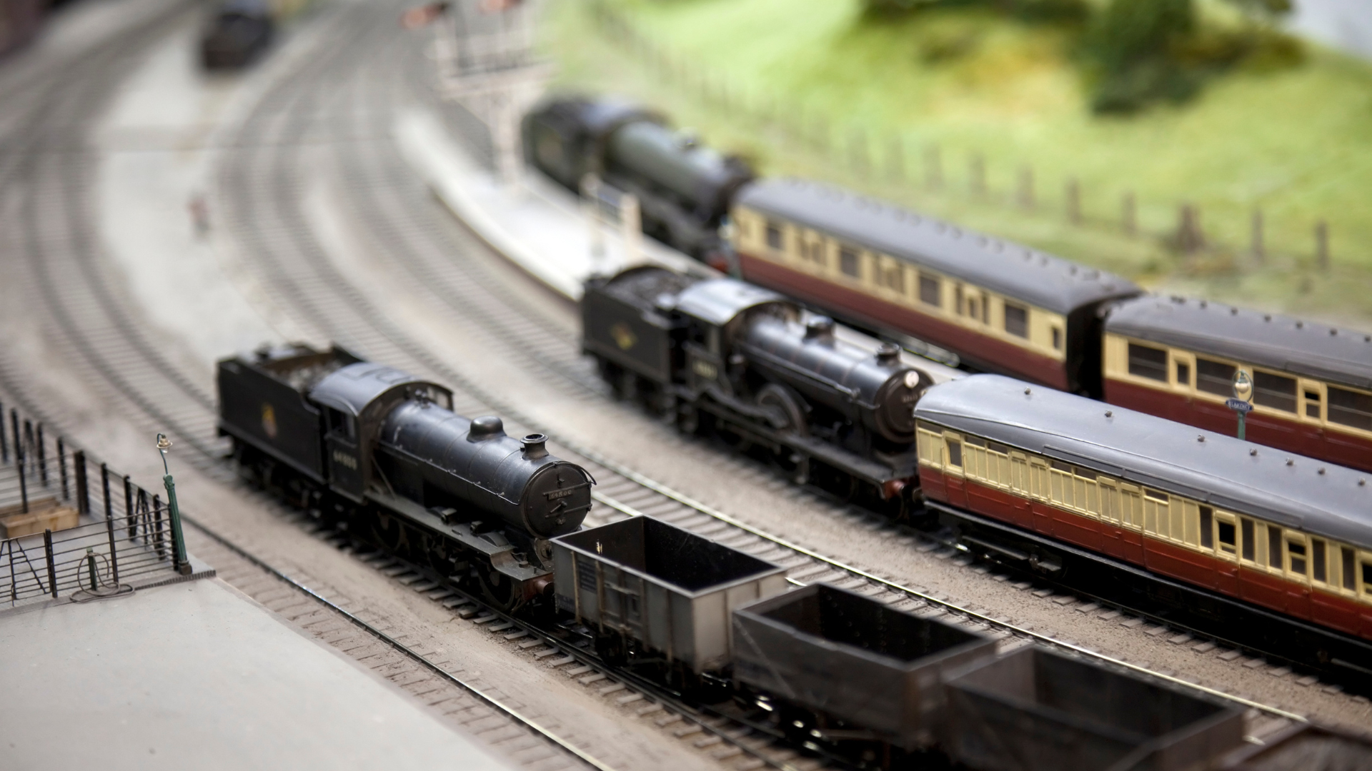 A toy train is sitting on top of a wooden table.