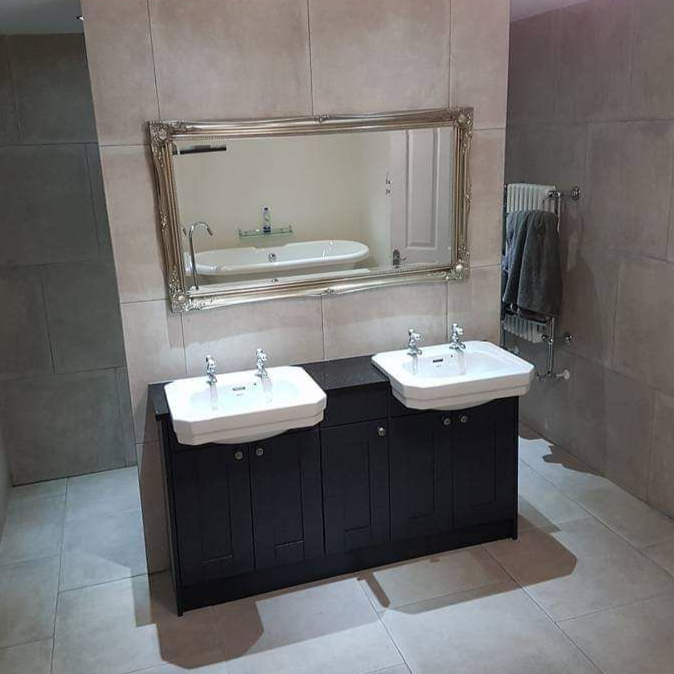 Bathroom with double basin vanity and large mirror