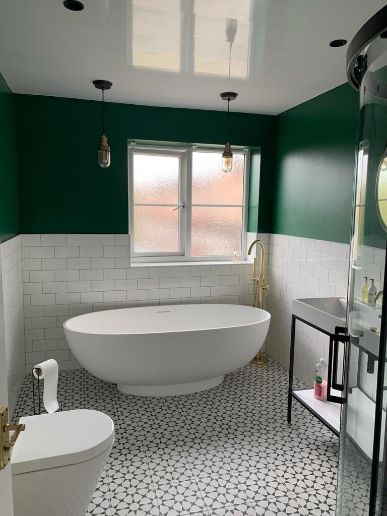 Family bathroom with freestanding bath and green walls