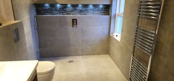 Tiled wet room with a feature niche and LED lighting