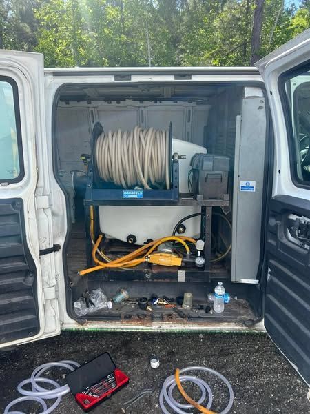 Open van with hose-reel equipment and tools in the rear compartment