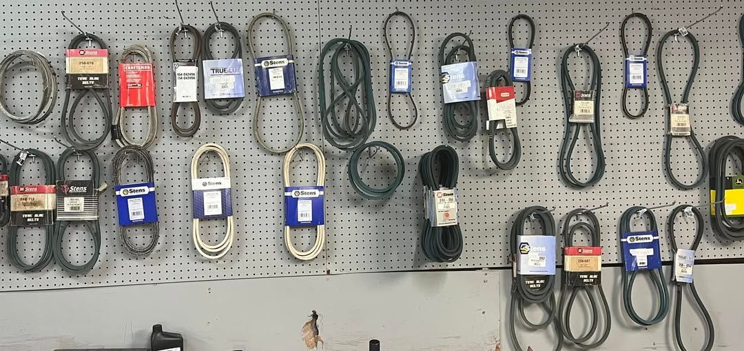 Pegboard display of assorted wall chargers and cables in black, white, red, and blue packaging