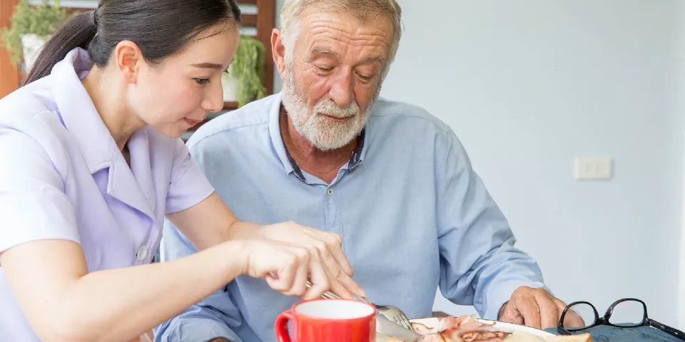 Caregiver Preparing Food for the Old Man — Brooklyn, NY — Safe Haven Home Care