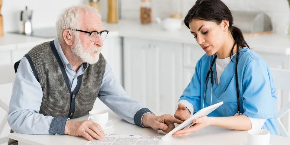 Caregiver Showing Something on the Tablet — Brooklyn, NY — Safe Haven Home Care