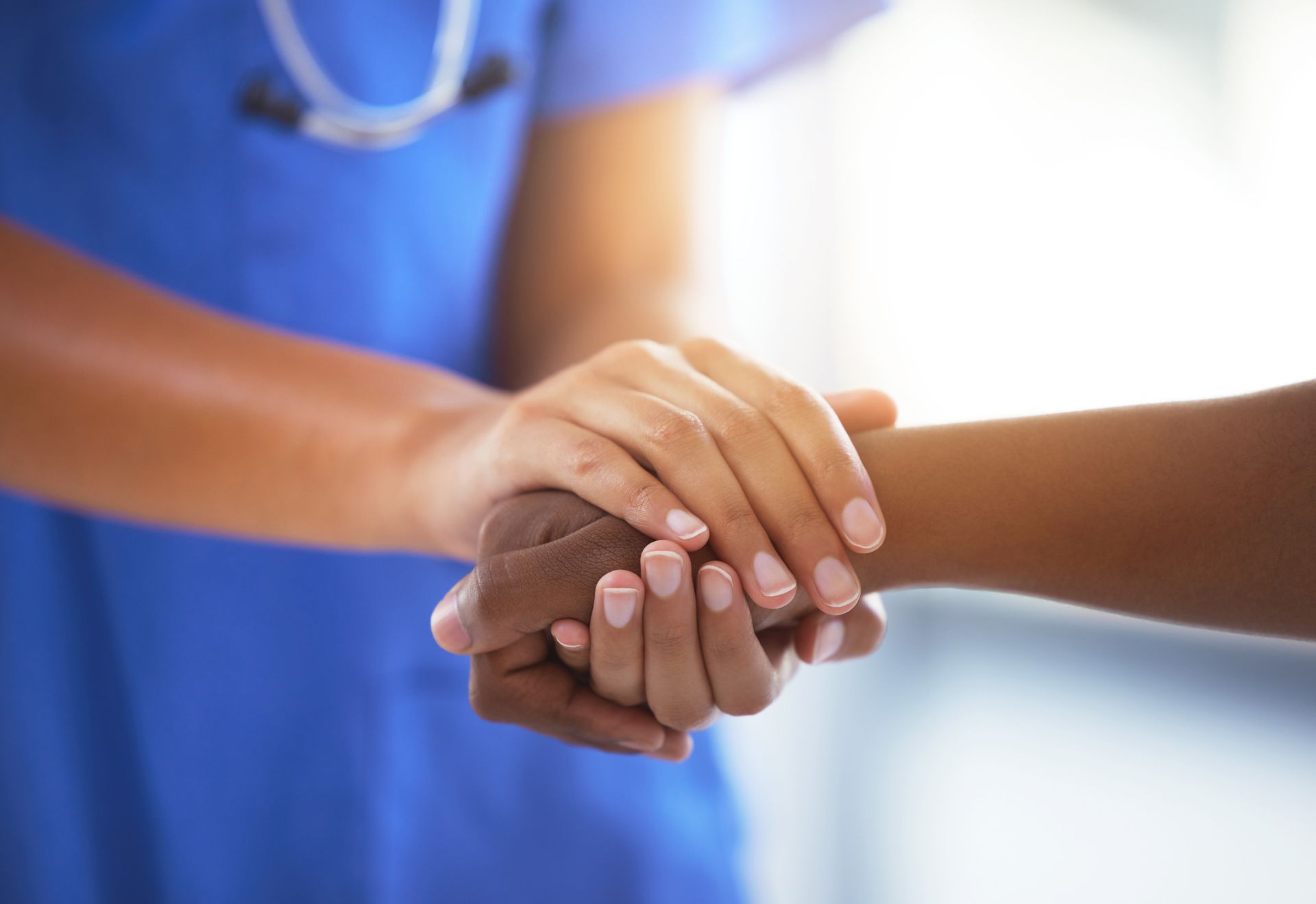 Young woman in blue scrubs, smiling with arms crossed, stethoscope around her neck. Young woman in blue scrubs, smiling with arms crossed, stethoscope around her neck.