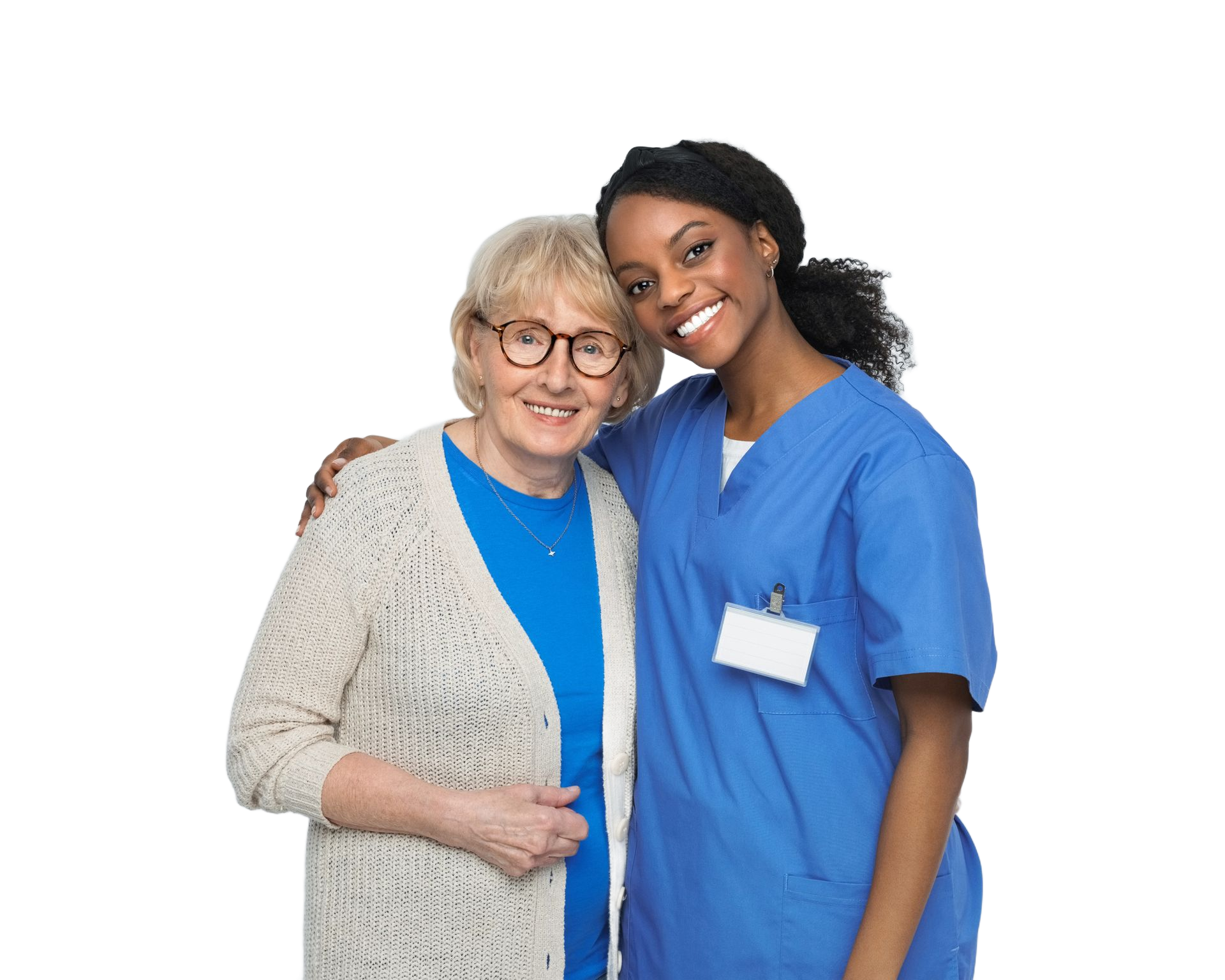 A smiling elderly woman and a smiling young Black woman in blue scrubs embrace, on a white background.
