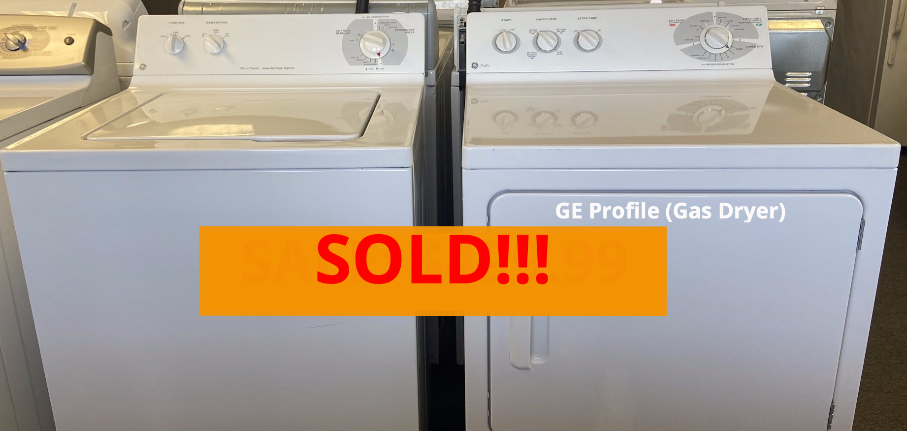 A washer and dryer are sitting next to each other with a sold sign.