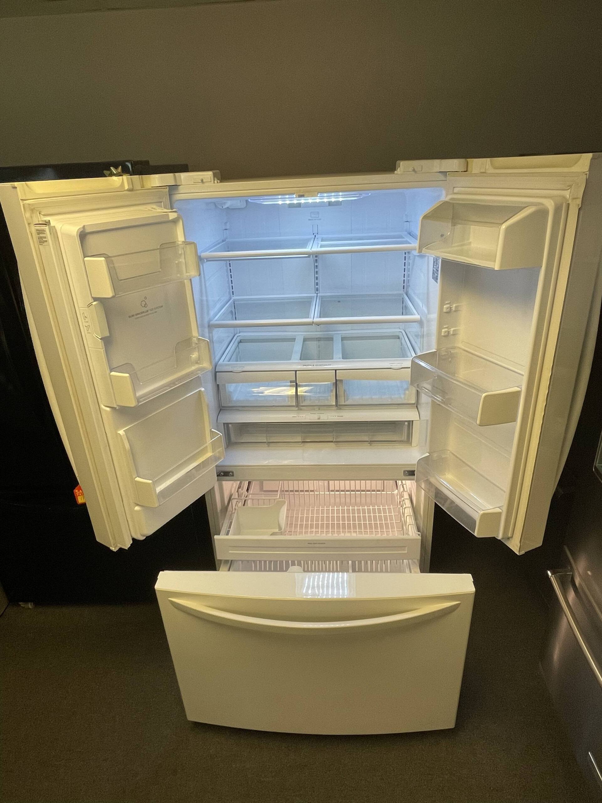 A white refrigerator with the door open and the freezer drawer open.