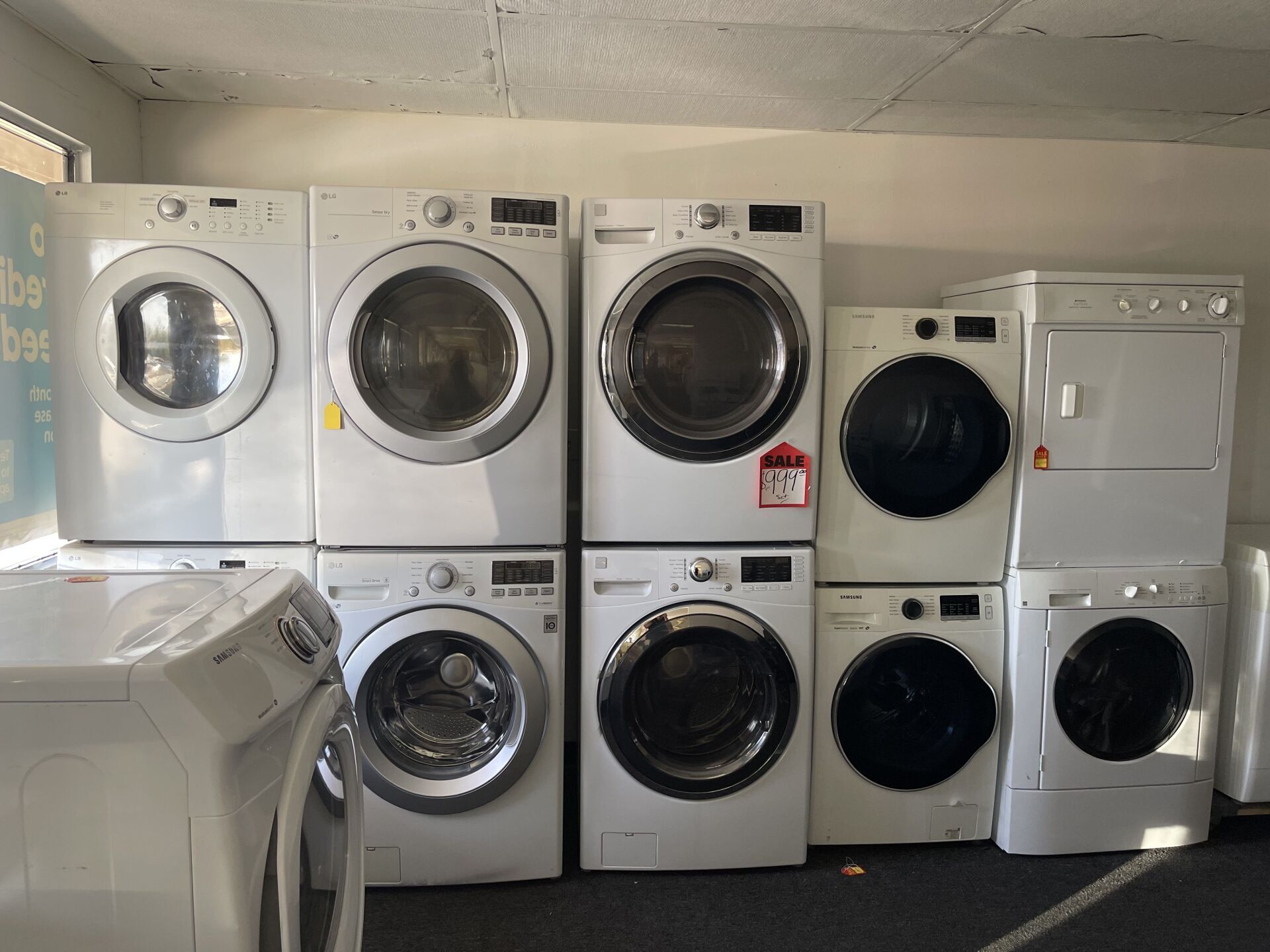A room filled with washers and dryers stacked on top of each other.