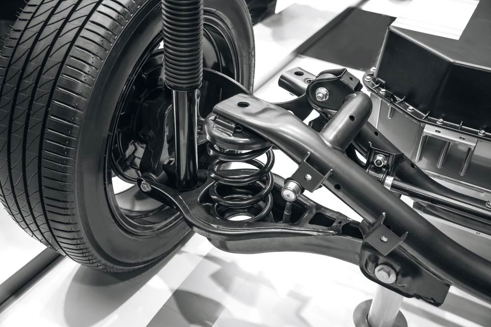 A Close Up of a Car Suspension With a Tire in the Background — K & T Ballina Mechanical In Ballina, NSW