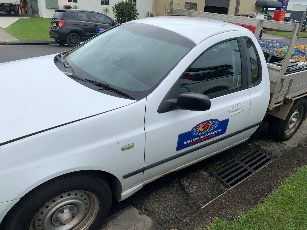 A White Truck is Parked on the Side of the Road — K & T Ballina Mechanical In Ballina, NSW