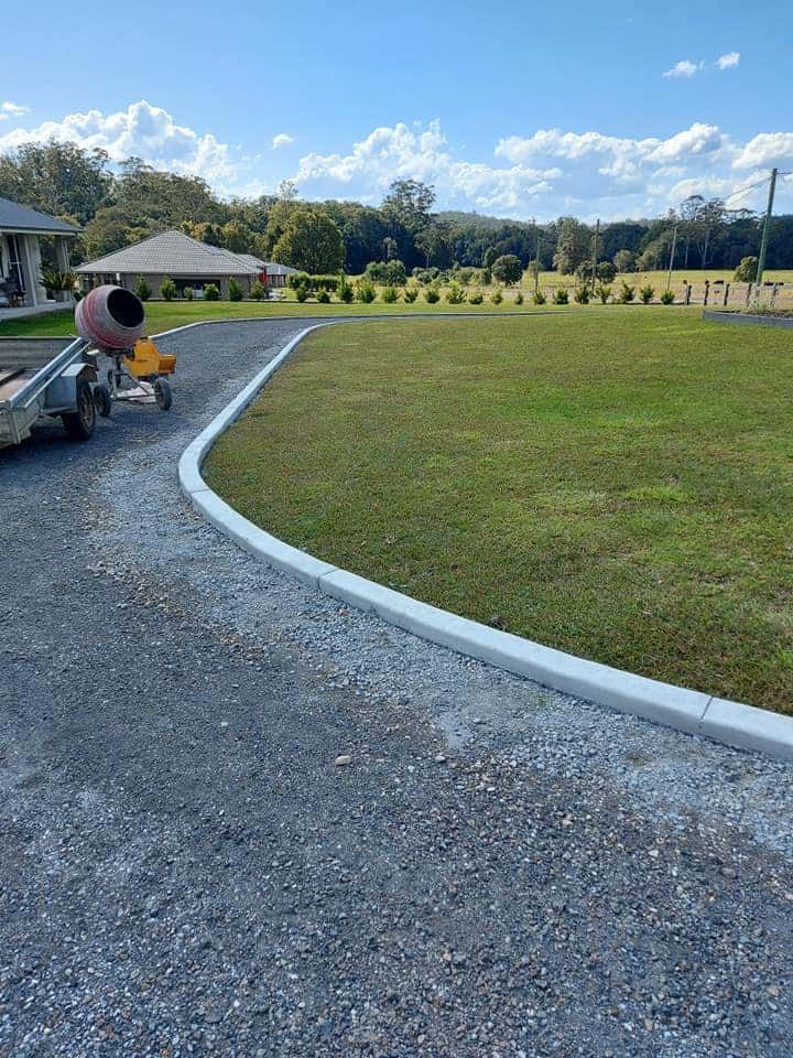 Wide Gravel Driveway Curves Bordered by White Kerbs — Brett's Continuous Garden Edges In Lakewood, NSW