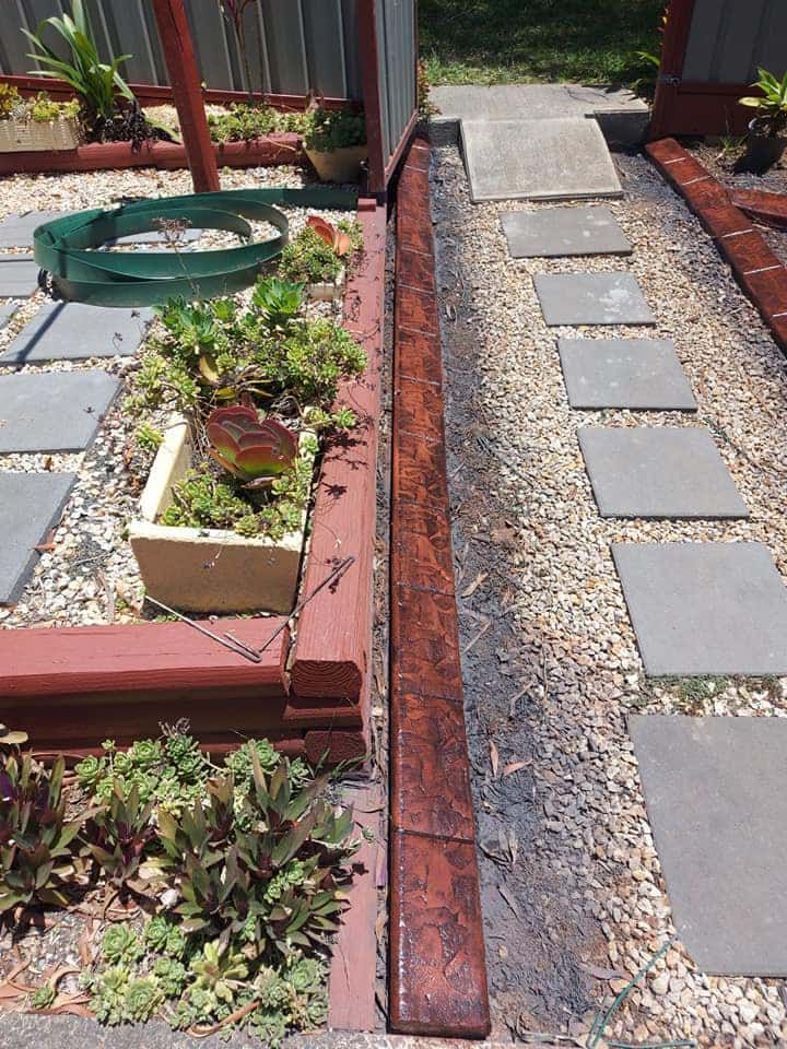 Raised Garden Bed With Succulents and Vibrant Red Edging — Brett's Continuous Garden Edges In North Haven, NSW