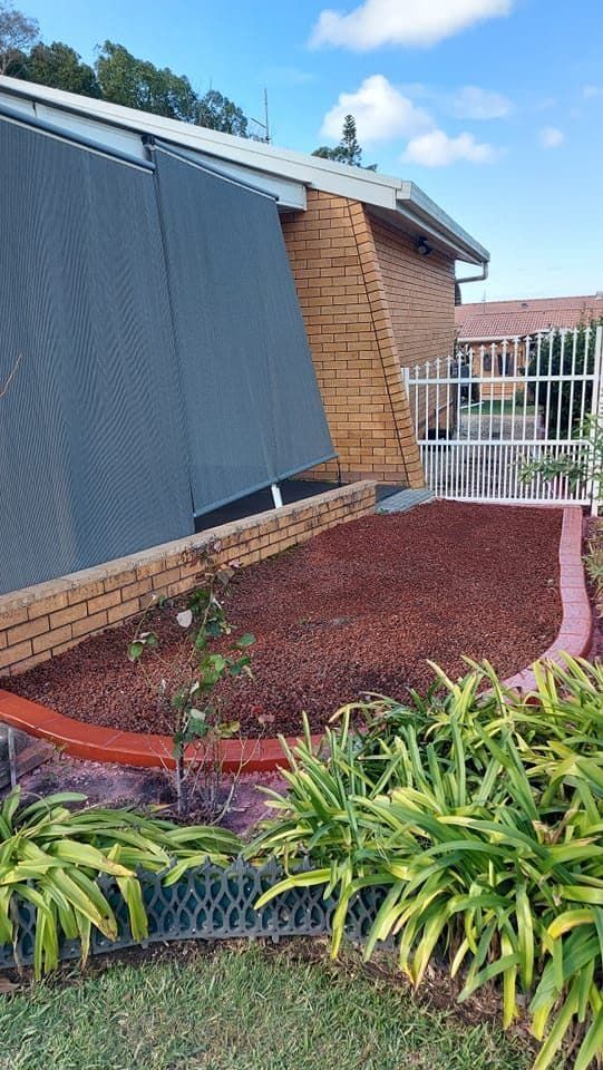 Brick House With Large Grey Shades — Brett's Continuous Garden Edges In Laurieton, NSW
