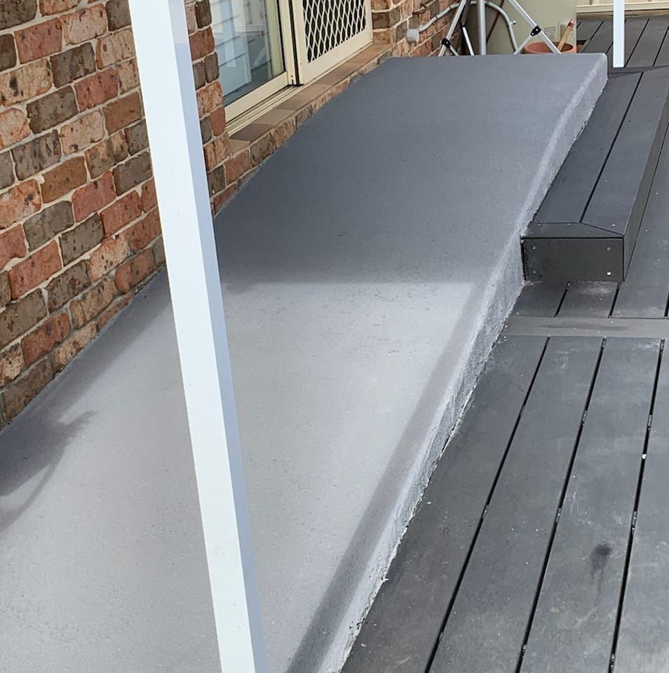 Grey Concrete Step Leading to a Wooden Deck — Brett's Continuous Garden Edges In Lake Cathie, NSW