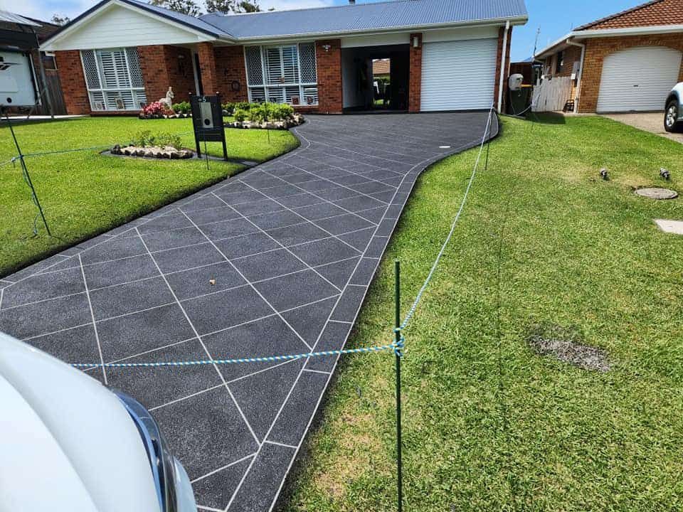 Freshly Paved Driveway With a Grid Pattern — Brett's Continuous Garden Edges In Lakewood, NSW