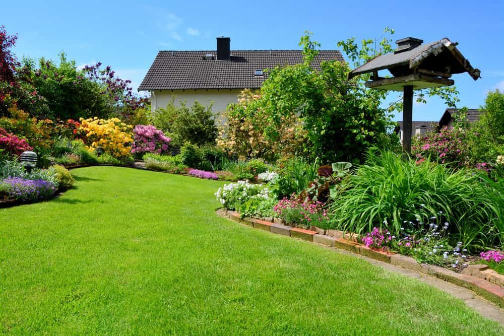 A Lush Garden With Vibrant Flowers — Brett Continuous Concrete Kerbing & Edging In Lakewood, NSW