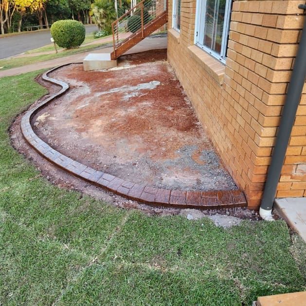 A Brick House With a Curved Sidewalk — Brett's Continuous Garden Edges In Lakewood, NSW