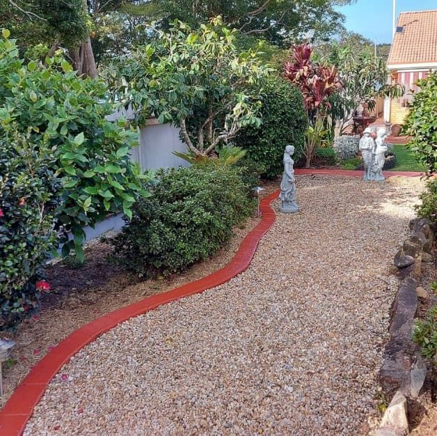 A Gravel Path With a Red Border in a Garden — Brett's Continuous Garden Edges In Lakewood, NSW