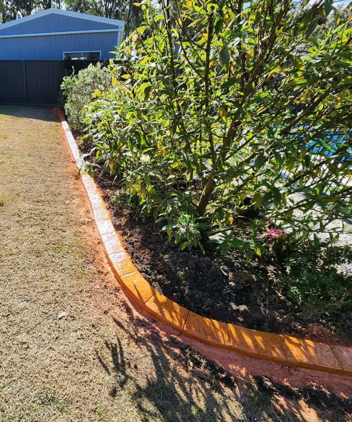 Curved Garden Bed With Orange Brick Border — Brett's Continuous Garden Edges In Lake Cathie, NSW