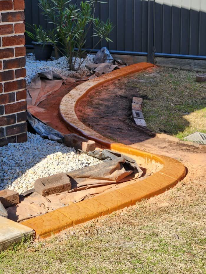 Curved Concrete Border Separates a Grassy Area — Brett's Continuous Garden Edges In Bonny Hills, NSW