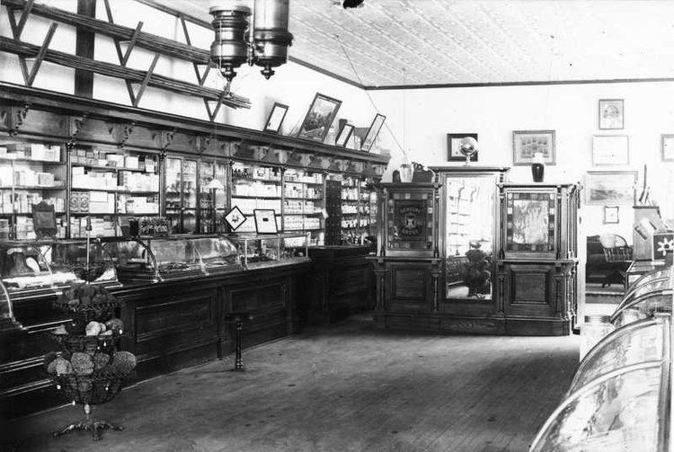 A black and white photo of the inside of a store.