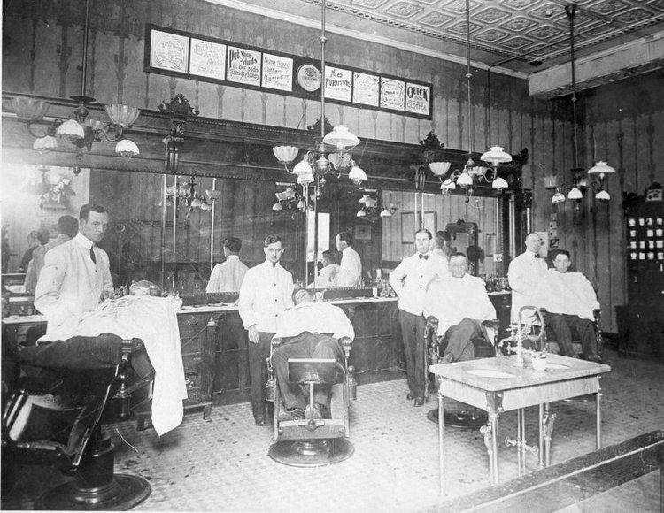 A group of men are getting their hair cut in a barber shop