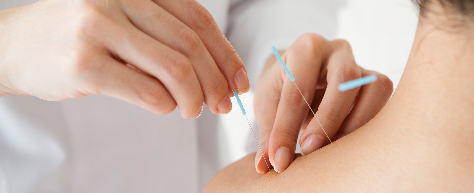 A close up of a person getting a needle in their arm.